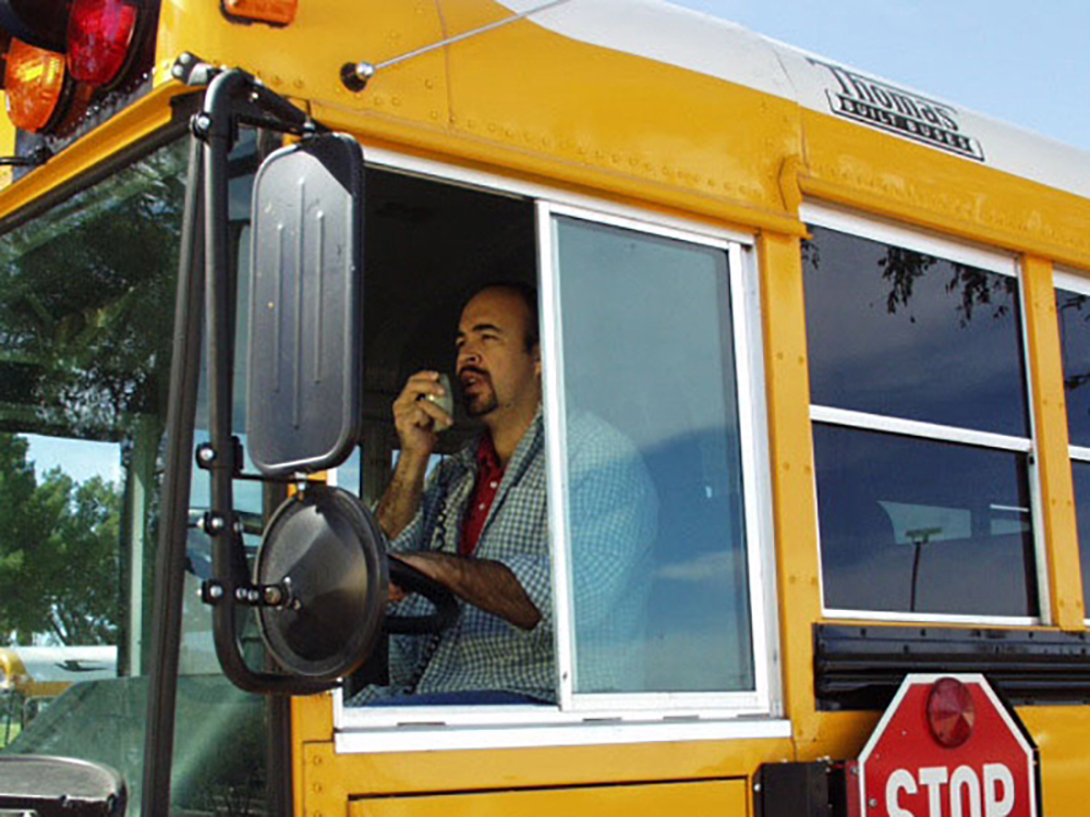 School bus driver using radio